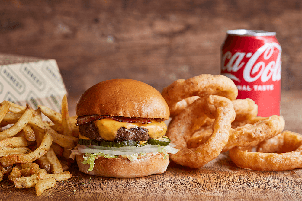 Tribute burger with chips, onion rings, chips and coke