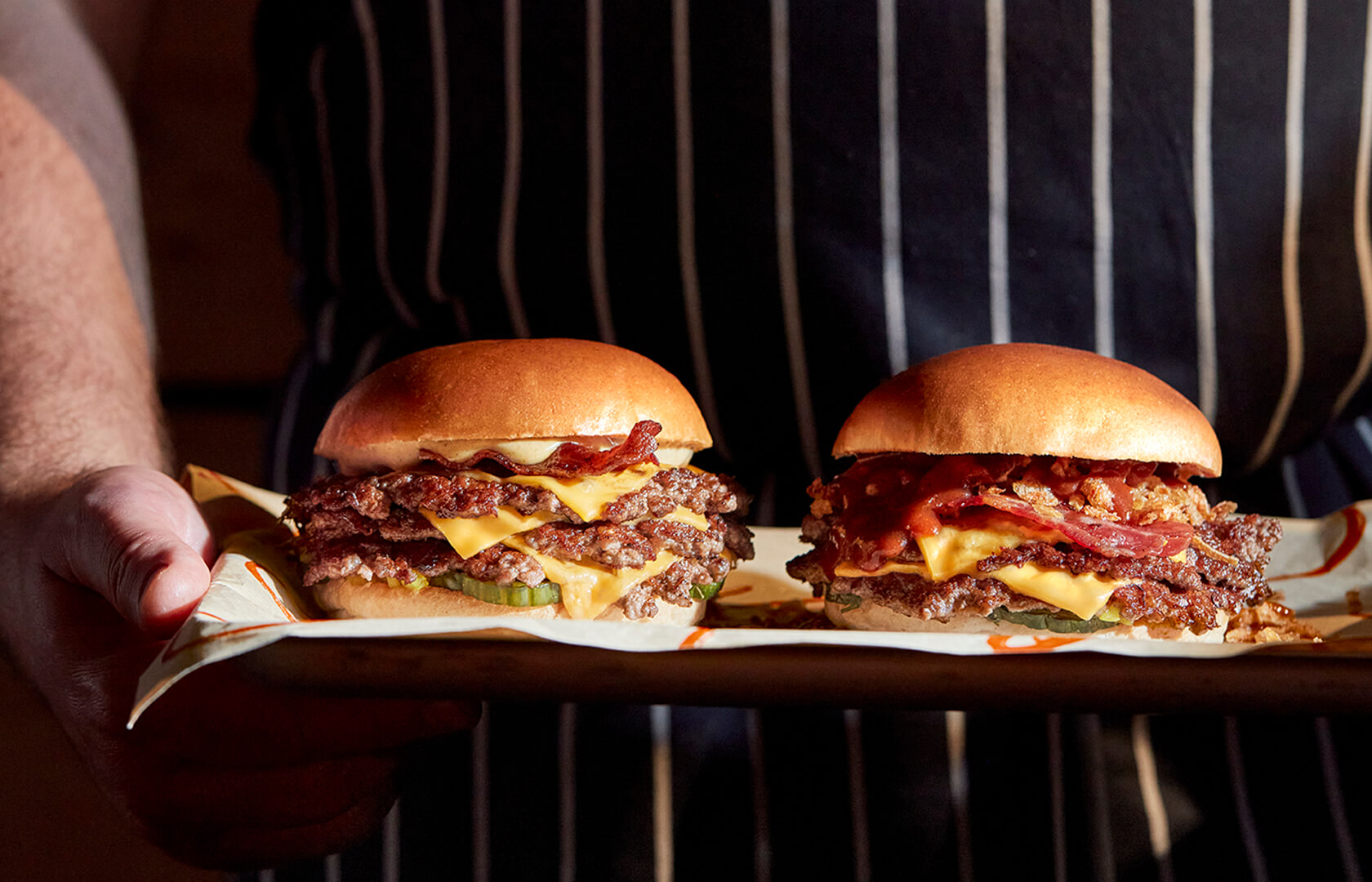 Double and triple smashed burgers on tray