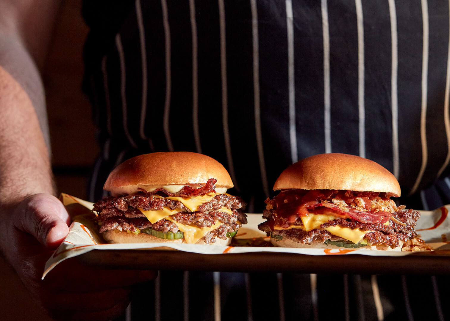 Double and triple smashed burgers on tray